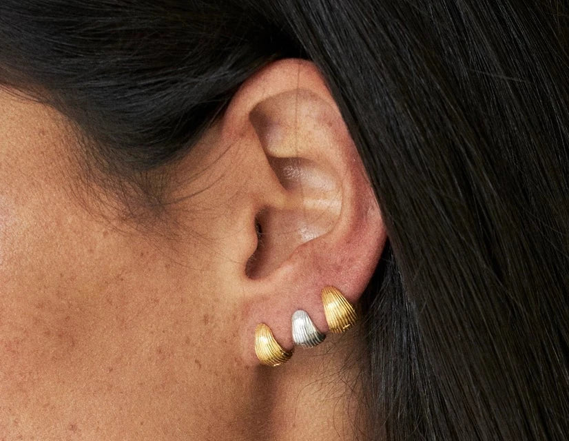 best Black Friday earrings featuring elegant sculptural studs in silver and gold.