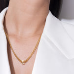 model wearing alphabet necklace with pendant E in gold