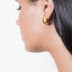 model wearing constantin earrings in gold