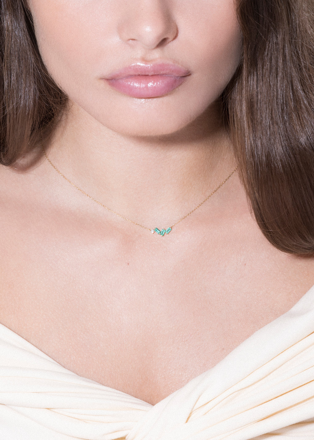 model wearing emerald and diamond 18k necklace