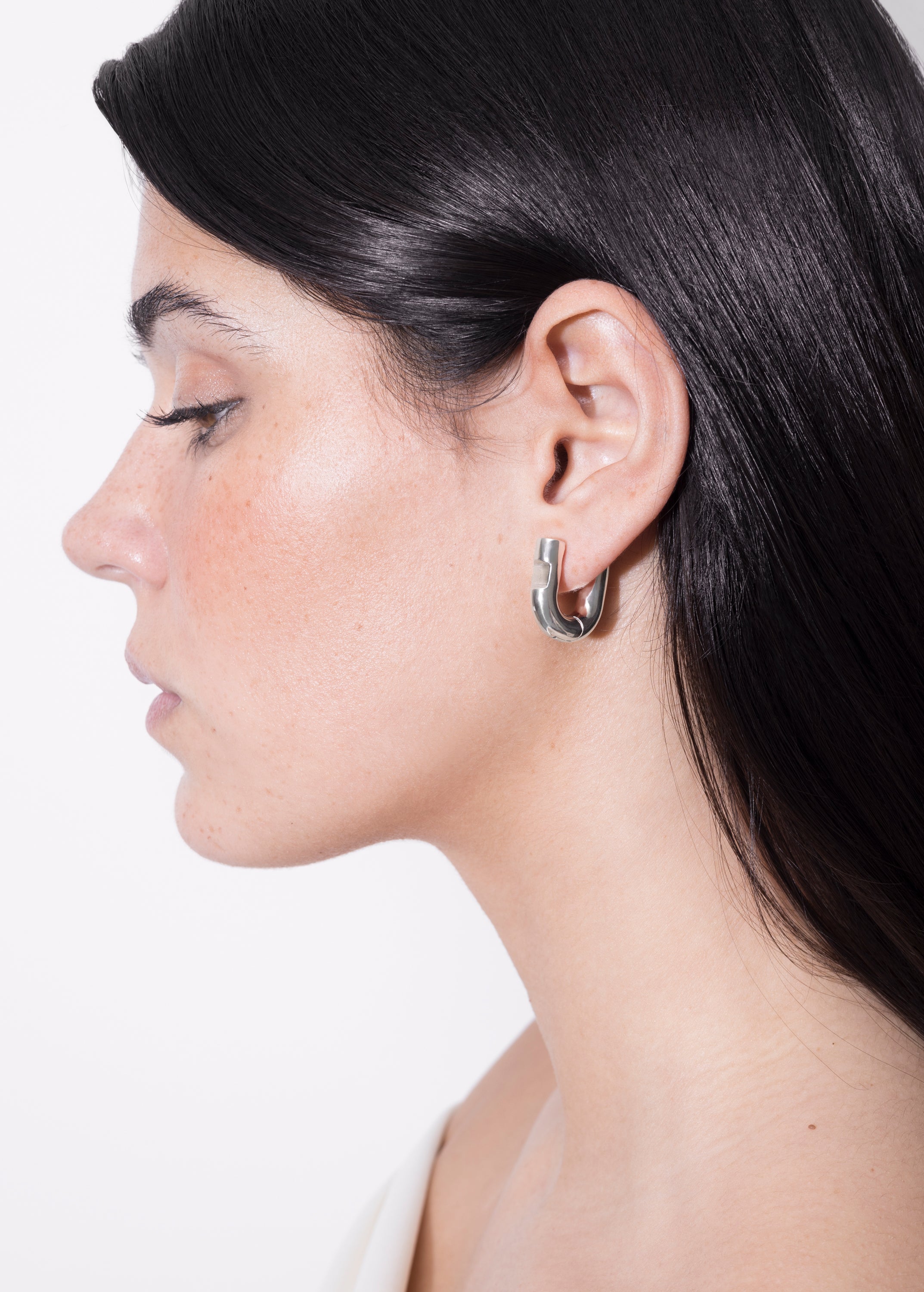 model wearing harpa earrings in silver