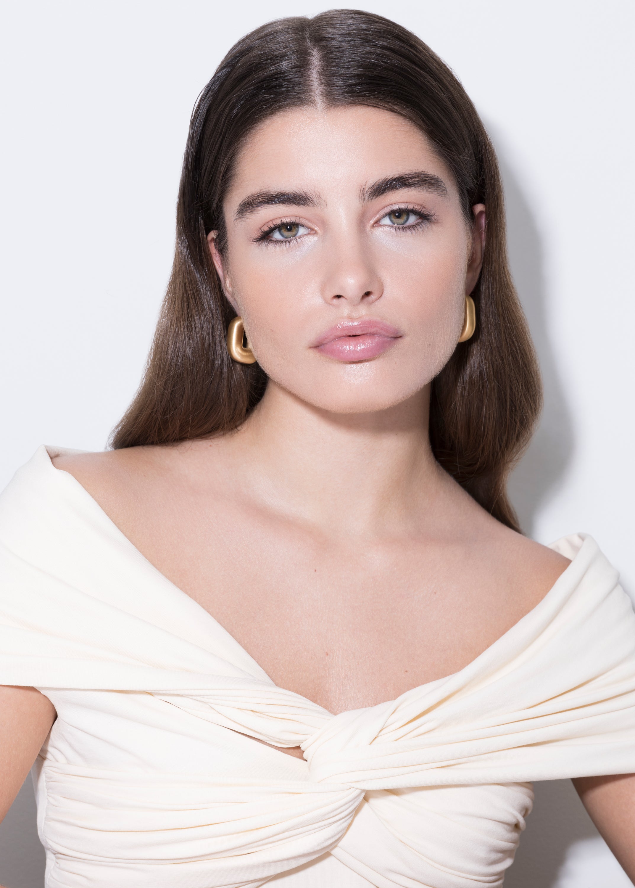 model wearing magda earrings in gold