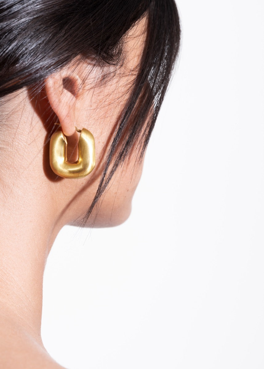 model wearing magda earrings in gold