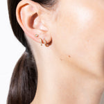 model wearing lime hoop 18k diamond and salt hoop 1k diamond