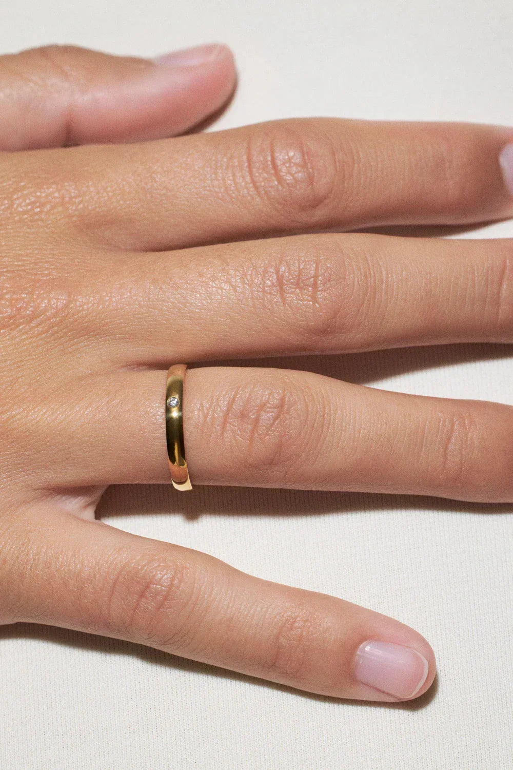 feminine wedding rings choice: elegant gold band on hand