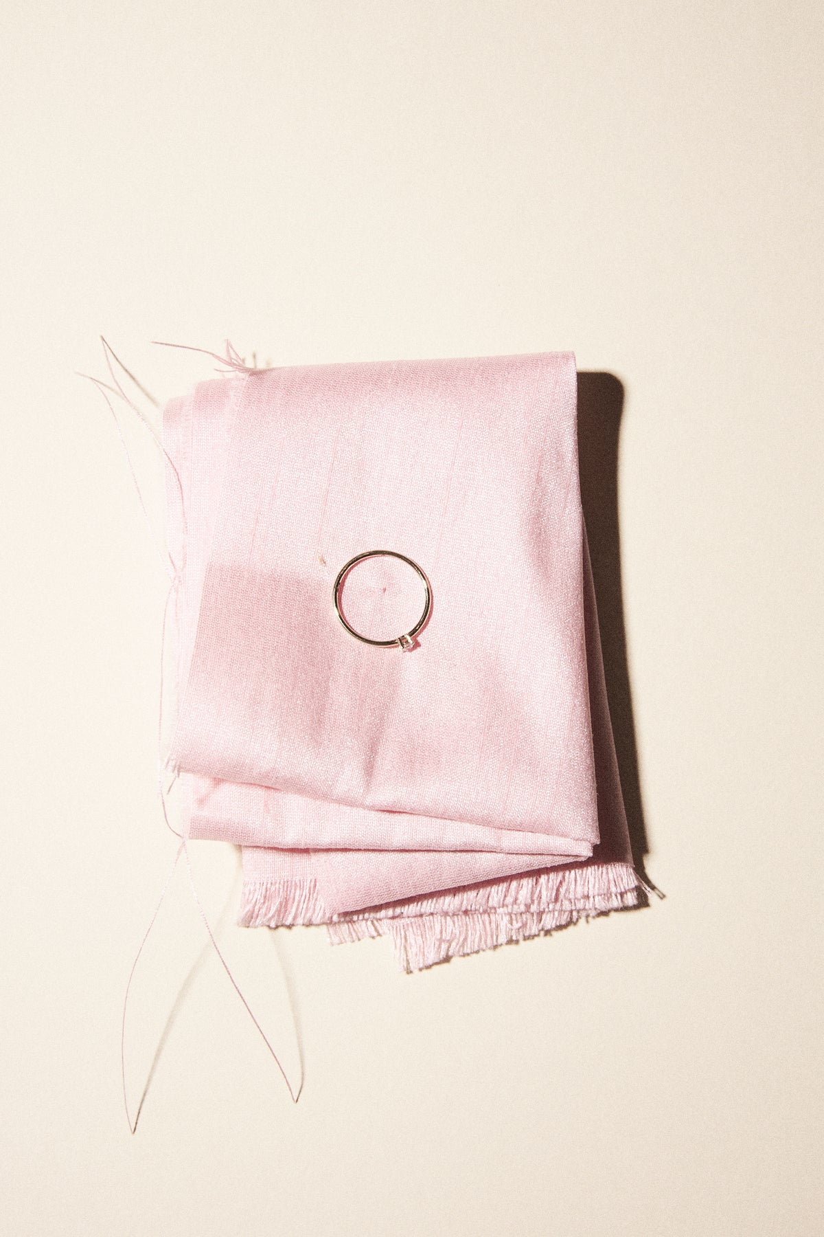 handmade wedding jewelry collection on a pink fabric background featuring a ring