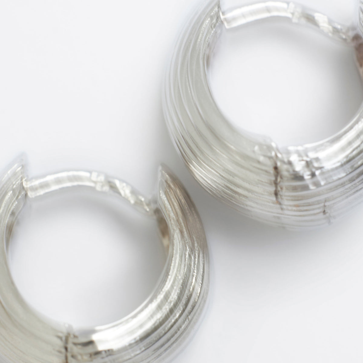 Meaningful jewelry gifts under 100 euros - elegant silver hoop earrings with a textured finish.