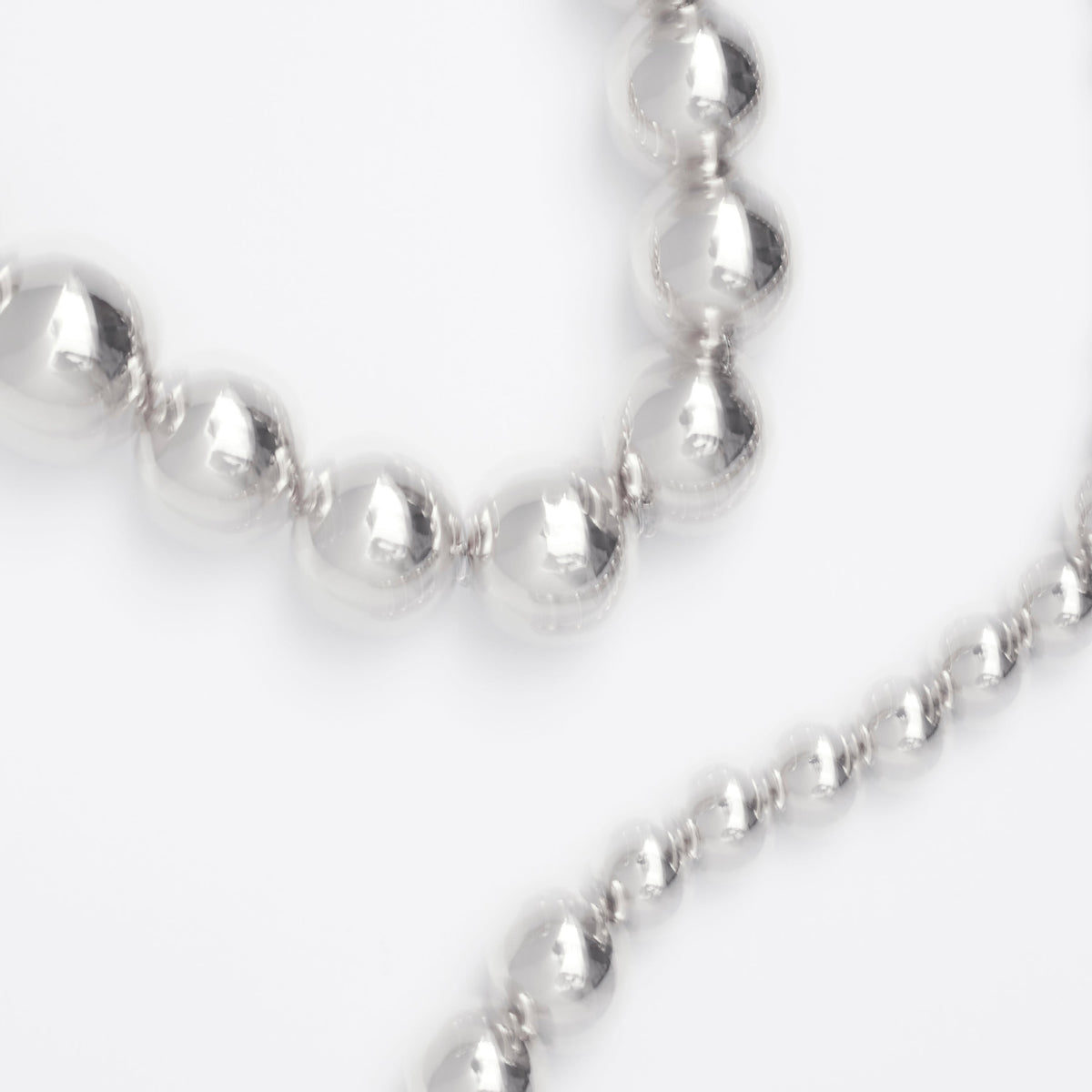 Affordable jewelry gifts under 150 euros featuring a silver beaded necklace.