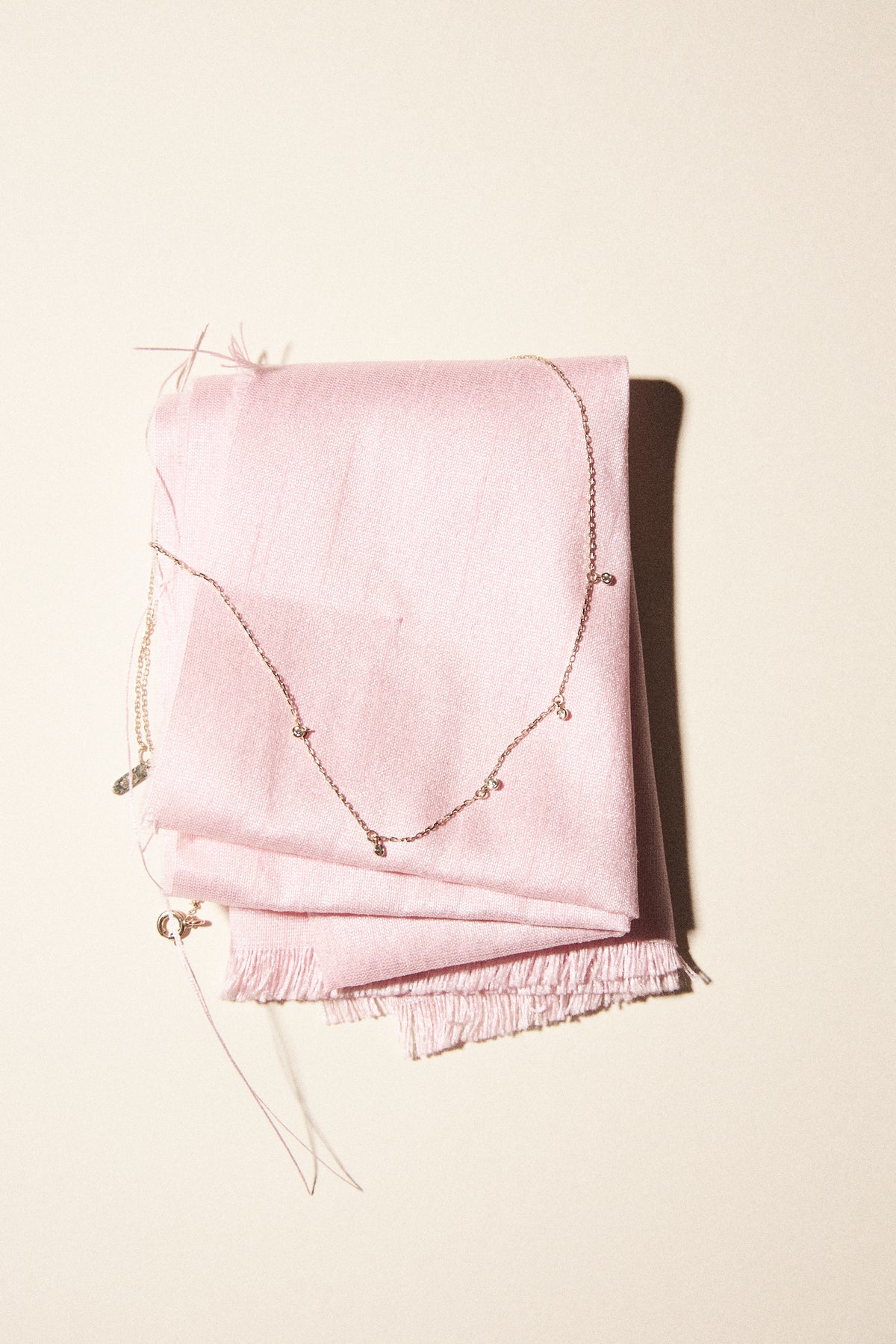 18k solid gold bracelets displayed on pink fabric