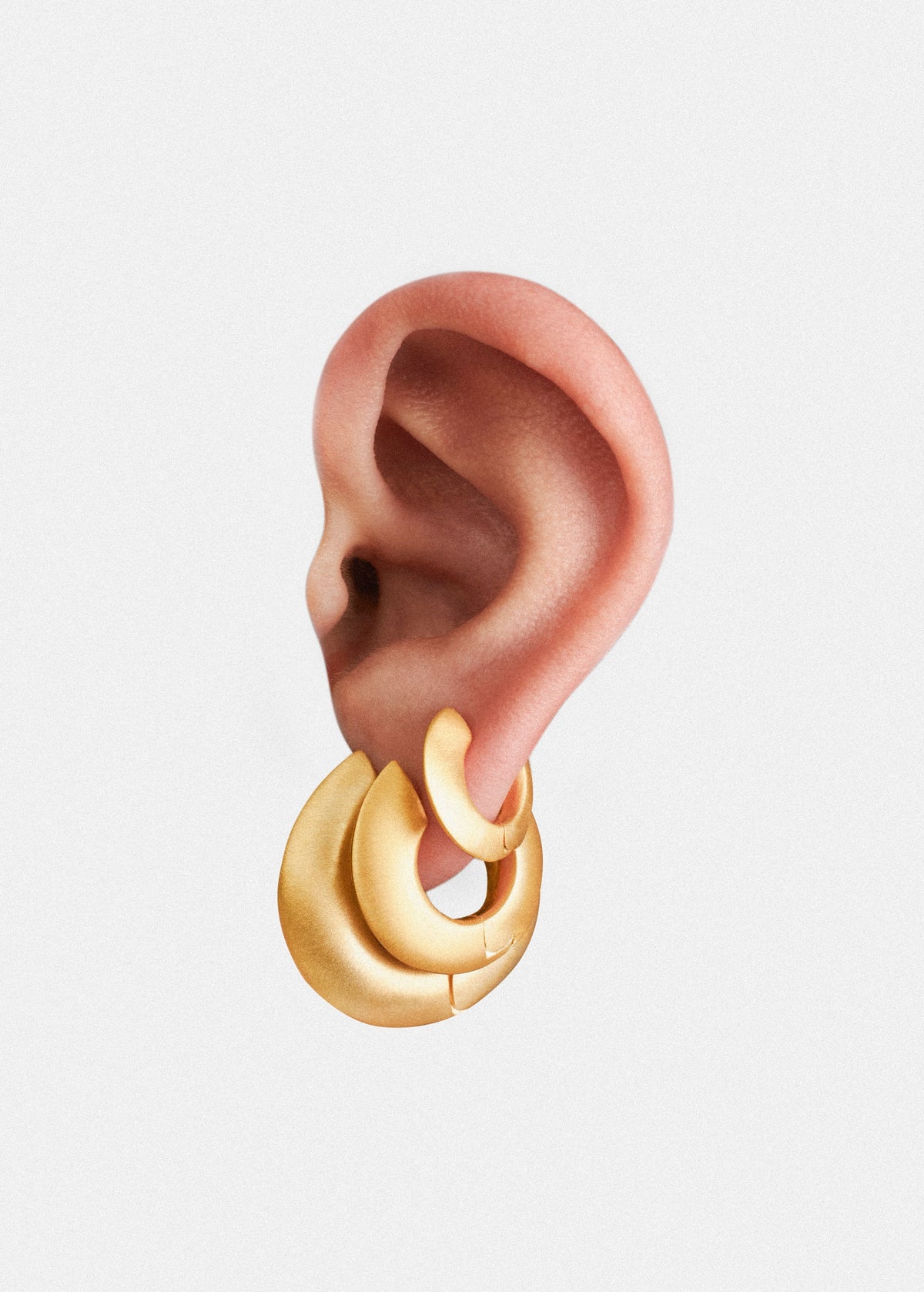 ear with iconic brushed finish earrings displayed elegantly