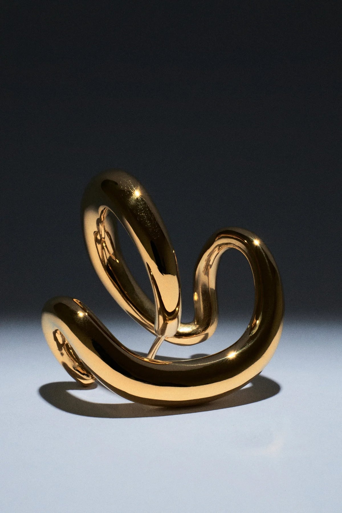 Stylish gold statement cuff bracelet showcasing a unique twisted design for modern fashion lovers.