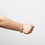 model wearing kids bracelet with letter M and C in silver