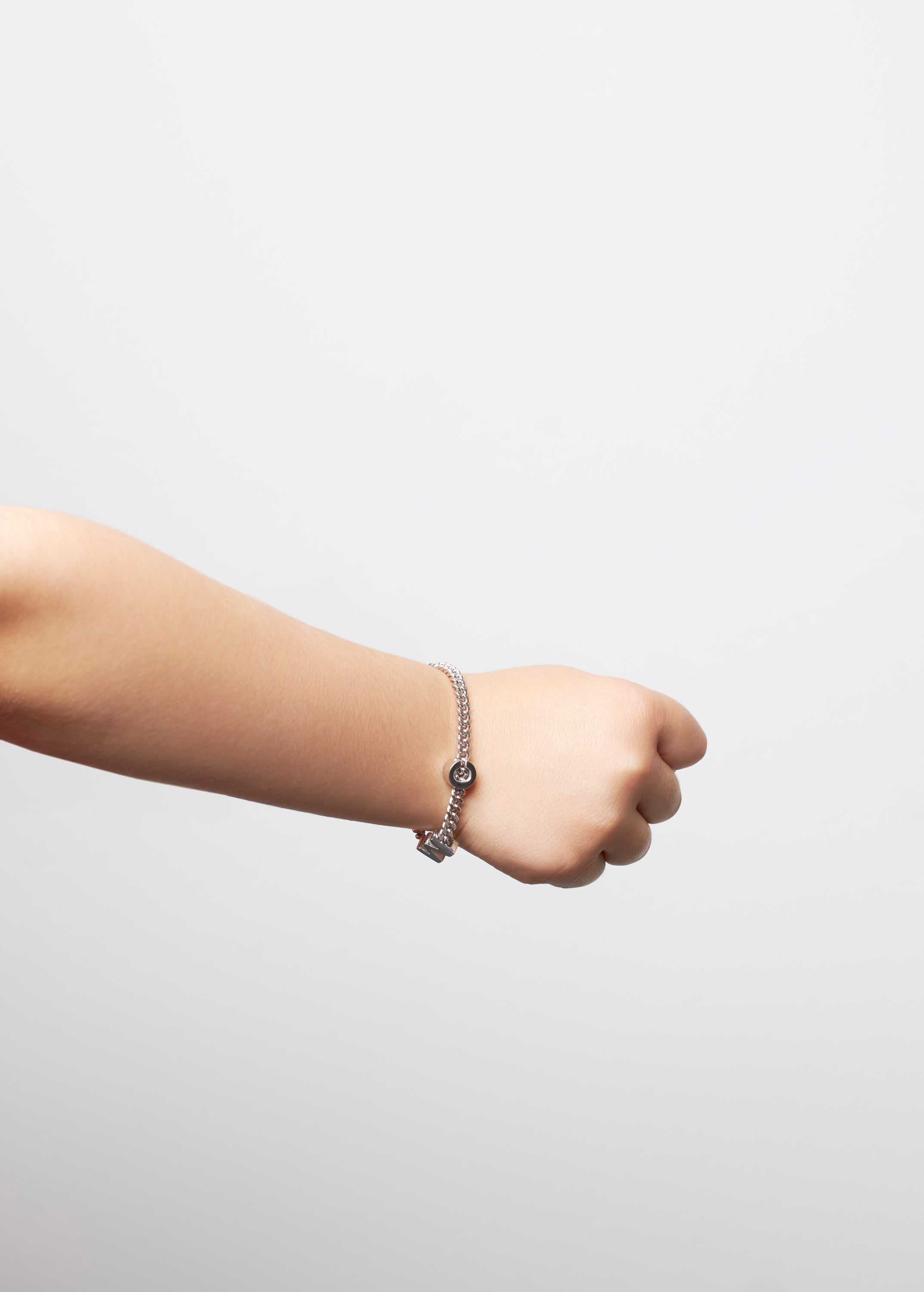 model wearing kids bracelet with letter M and C in silver