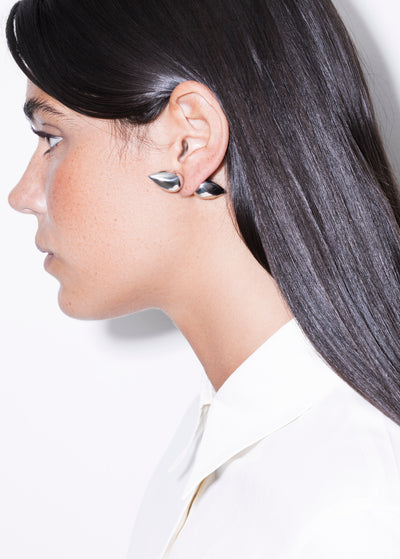 Profile view of a model wearing vintage gold plated earrings from CINCO Jewelry, showcasing elegant design.