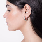 model wearing harpa earrings in silver
