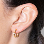 Detail of an ear with linda earrings gold