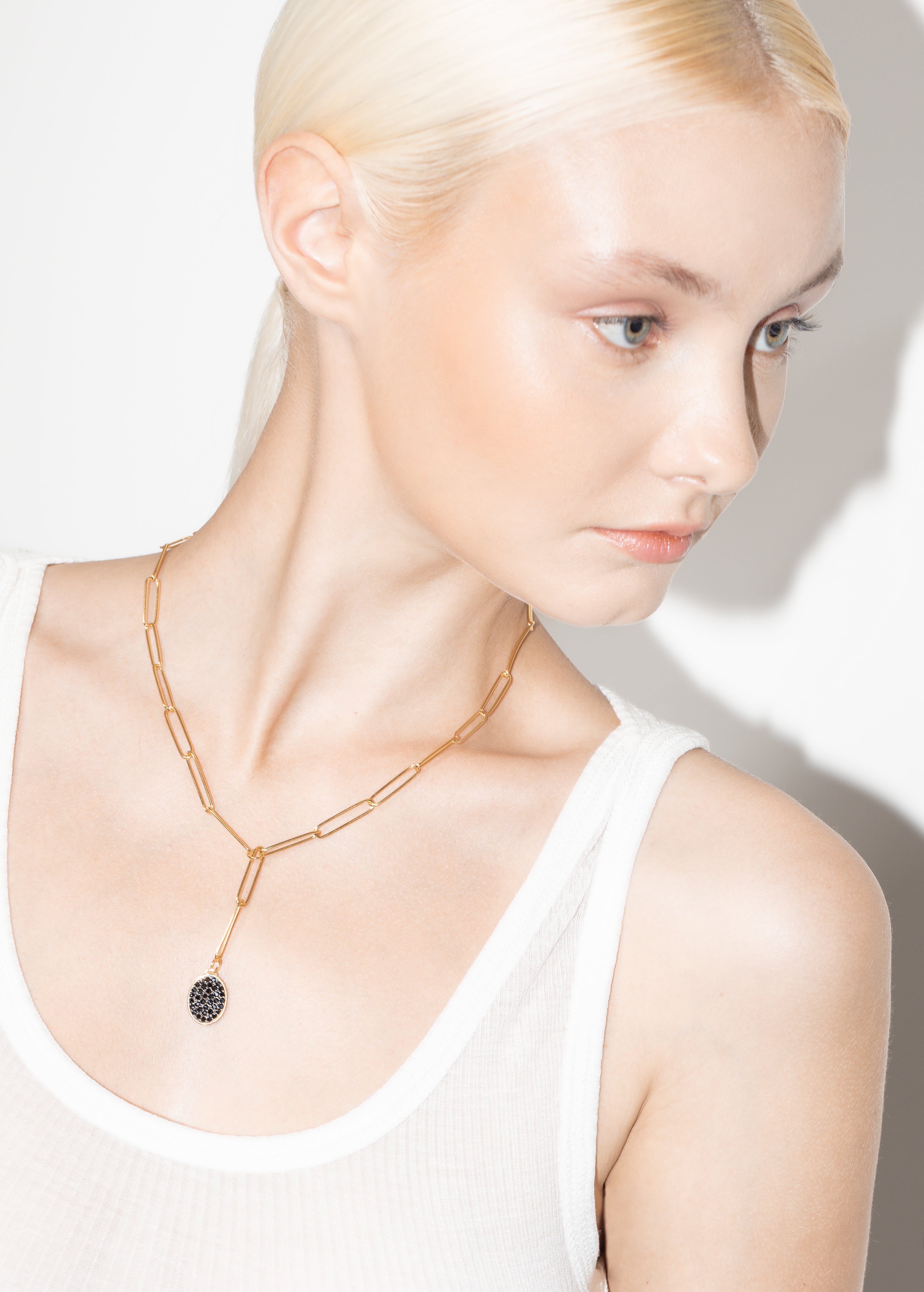 model wearing manu necklace black in gold