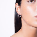 model wearing mini bia earrings in silver