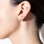 model wearing salt hoop 18k emerald, lime hoop 18k emerald, balalai stud 18k emerald and mush stud 18k emerald