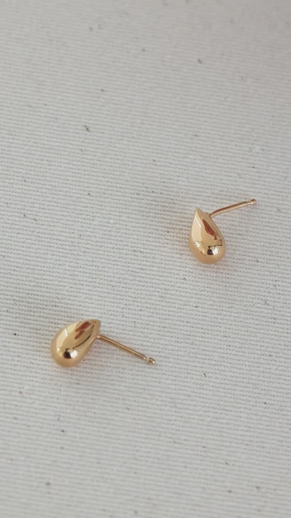 Model using constantin mini earrings in gold 