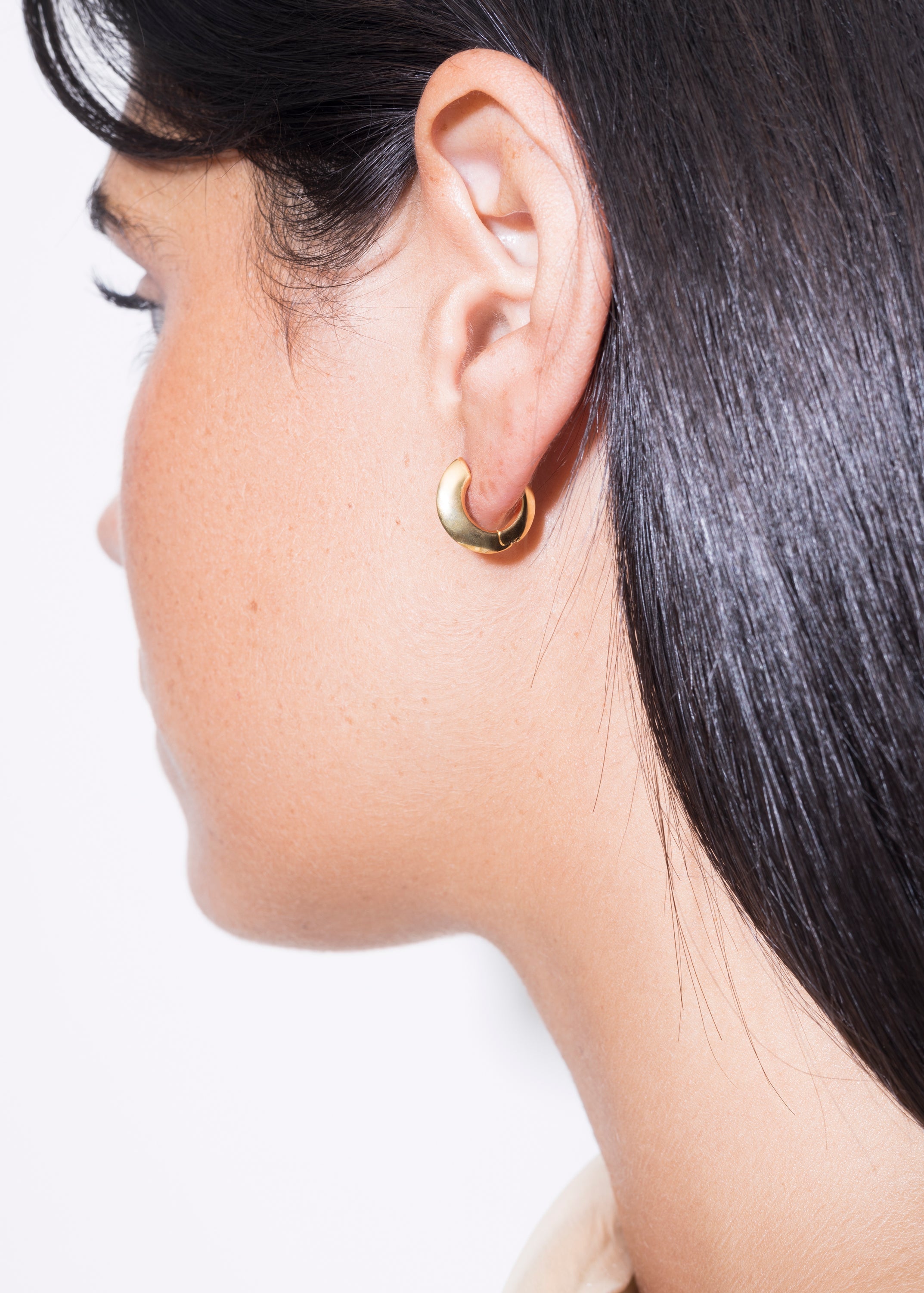 model wearing mini sarah polished earrings in gold