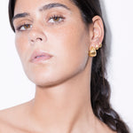 model wearing maxi tilly earrings and tilly earrings in gold